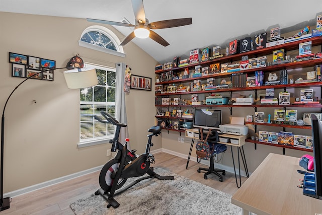 home office with lofted ceiling, a wealth of natural light, ceiling fan, and light hardwood / wood-style floors