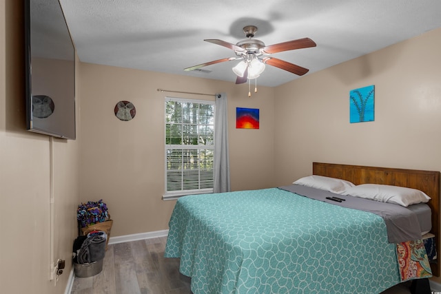 bedroom with hardwood / wood-style flooring and ceiling fan