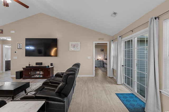 living room featuring lofted ceiling, ceiling fan, and light hardwood / wood-style floors