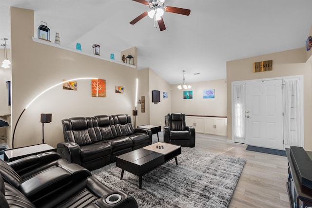 living room with ceiling fan with notable chandelier, light wood-type flooring, and high vaulted ceiling