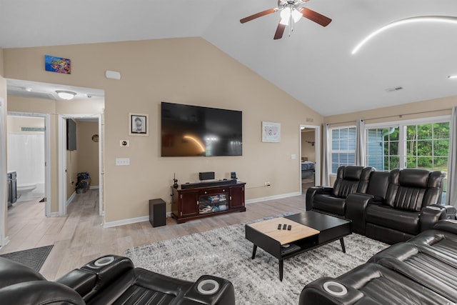 living room featuring lofted ceiling, light hardwood / wood-style flooring, and ceiling fan