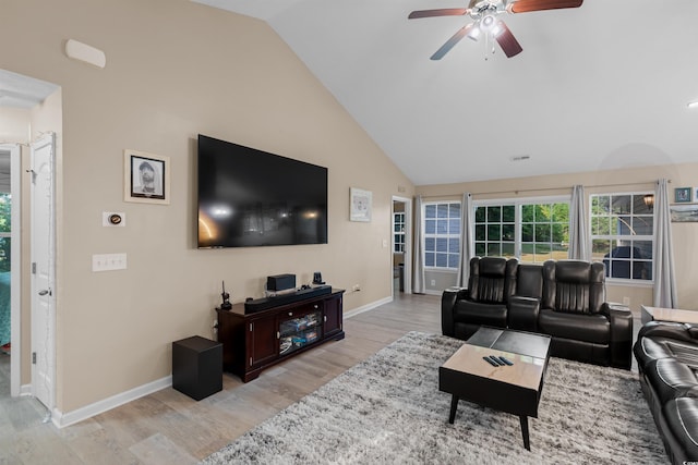 living room with lofted ceiling, ceiling fan, and light hardwood / wood-style flooring