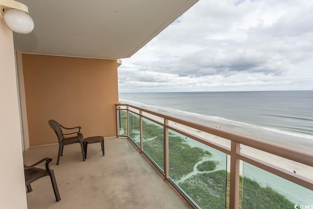 balcony with a view of the beach and a water view