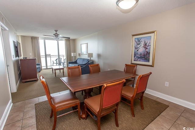 tiled dining area featuring ceiling fan and a textured ceiling