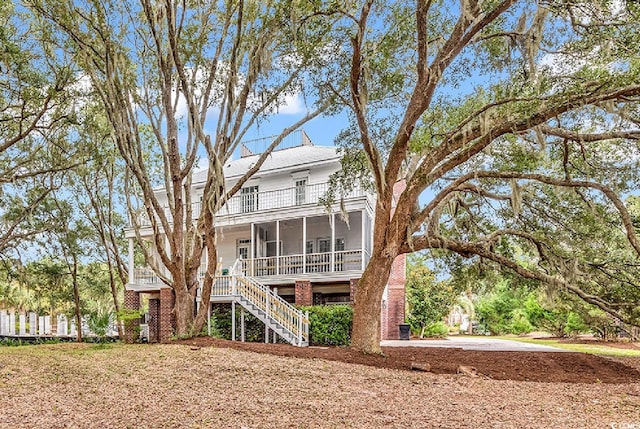 rear view of property with a porch