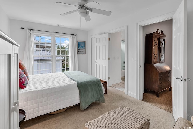 carpeted bedroom with ceiling fan and ensuite bath