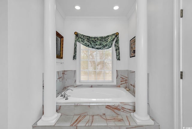 bathroom with tiled bath and ornamental molding