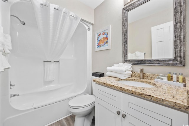 full bathroom featuring shower / bath combination with curtain, toilet, hardwood / wood-style flooring, and vanity