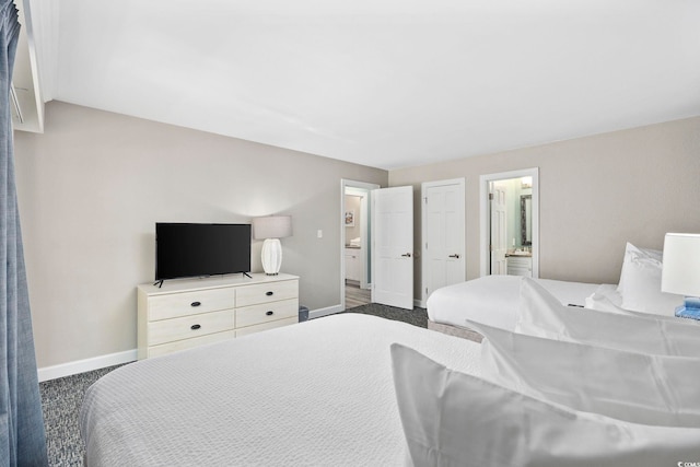 carpeted bedroom featuring ensuite bathroom