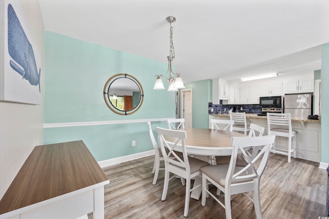 dining space with light hardwood / wood-style floors