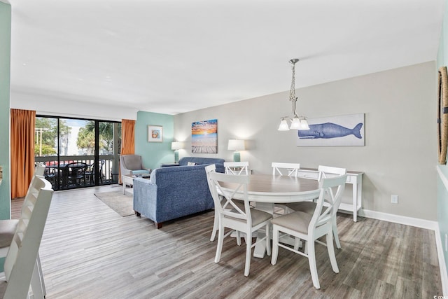 dining area featuring hardwood / wood-style flooring and a chandelier