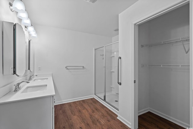 bathroom with vanity, walk in shower, and hardwood / wood-style flooring