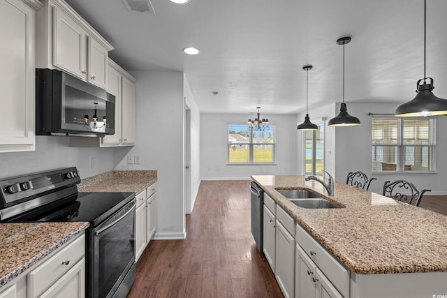 kitchen with a center island with sink, white cabinetry, dark wood-type flooring, sink, and stainless steel appliances