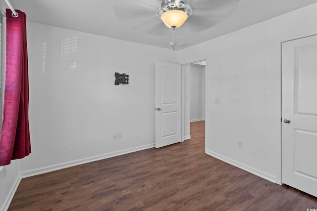 unfurnished bedroom with dark hardwood / wood-style floors and ceiling fan