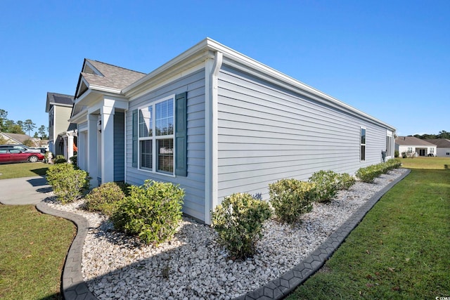 view of property exterior with a lawn