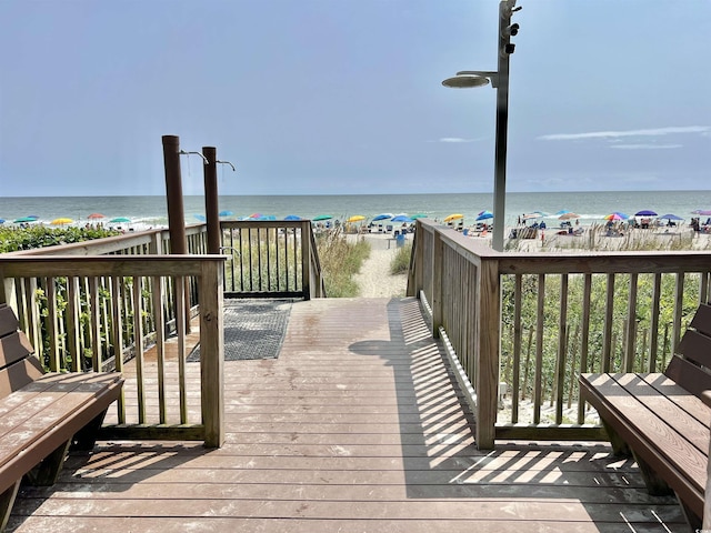 exterior space with a water view and a view of the beach