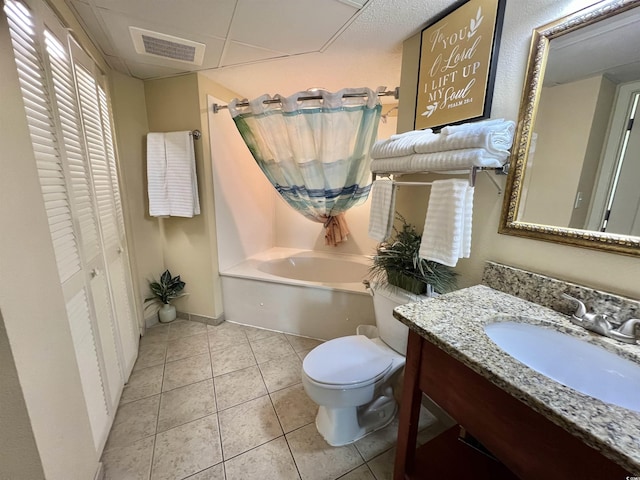 bathroom featuring vanity, tile patterned floors, a bathing tub, and toilet