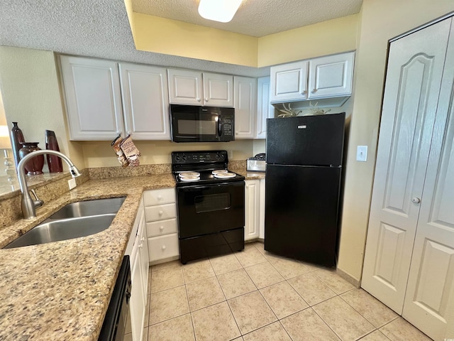 2504 N Ocean Blvd Unit 734, Myrtle Beach, SC 29577 - kitchen with black appliances, a textured ceiling, white cabinetry, light tile patterned floors, and light stone counters