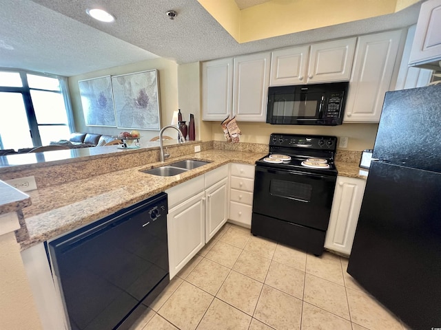 2504 N Ocean Blvd Unit 734, Myrtle Beach, SC 29577 - kitchen featuring black appliances, white cabinets, a textured ceiling, light tile patterned floors, and light stone counters