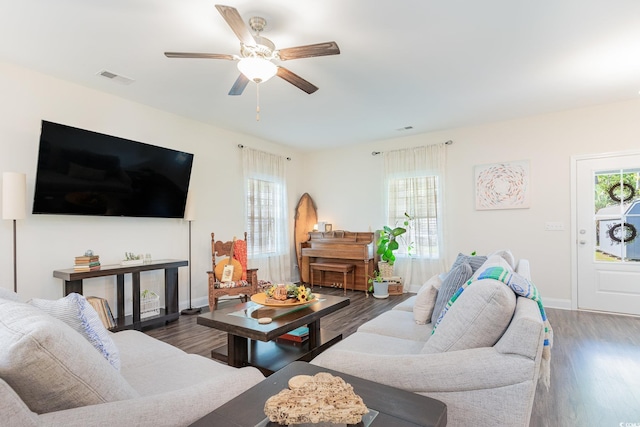 living room featuring ceiling fan and dark hardwood / wood-style flooring