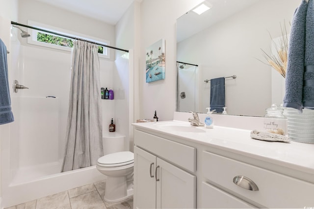 bathroom with toilet, a shower with curtain, vanity, and tile patterned flooring