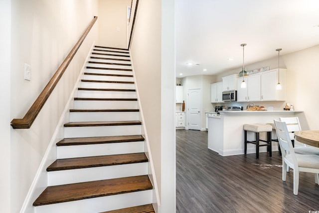 stairway featuring hardwood / wood-style floors