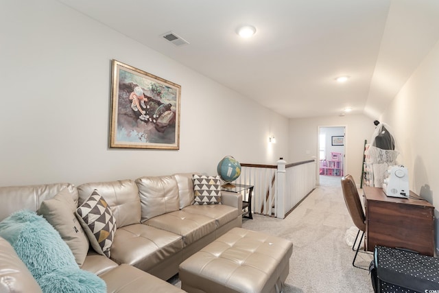 carpeted living room with vaulted ceiling