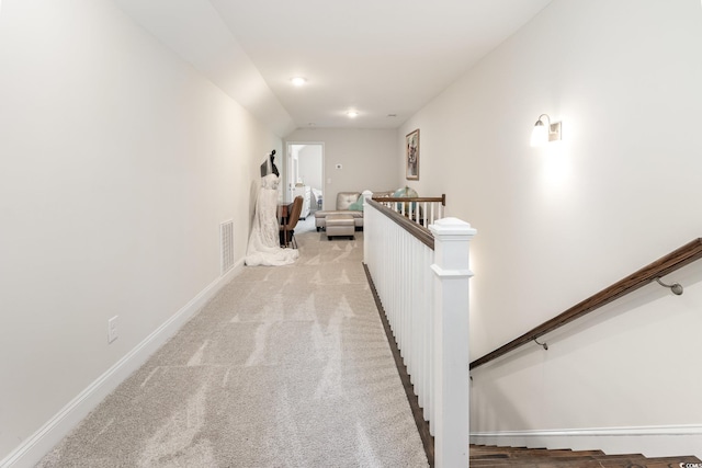 hallway with light colored carpet