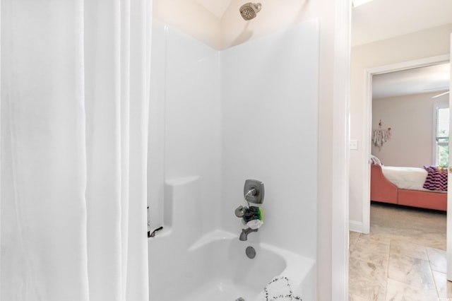 bathroom with shower / bath combo with shower curtain