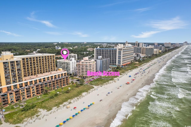 drone / aerial view featuring a water view and a beach view