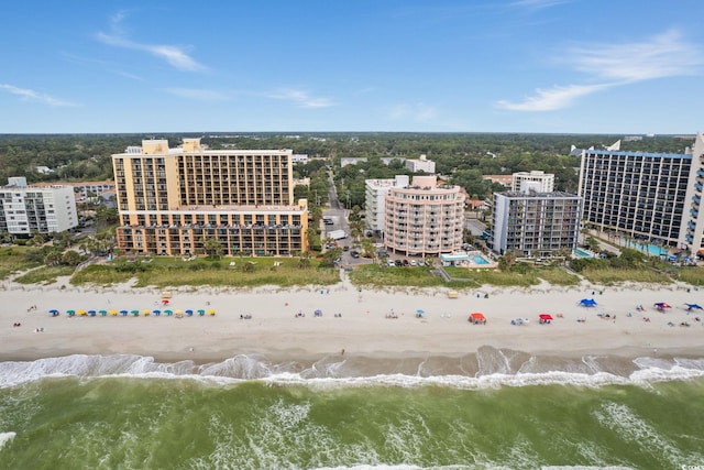 birds eye view of property featuring a water view and a beach view