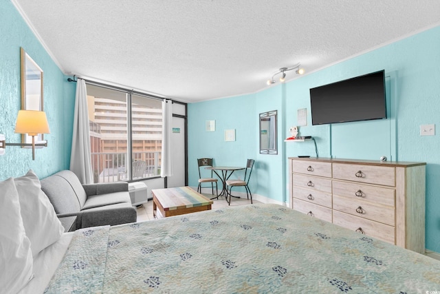 bedroom featuring crown molding and a textured ceiling