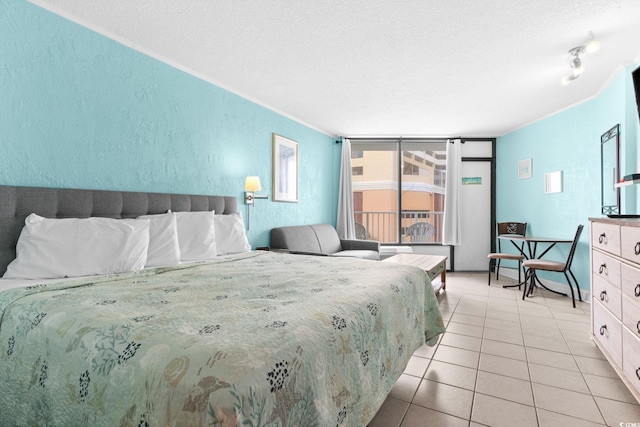 bedroom featuring light tile patterned flooring and a textured ceiling