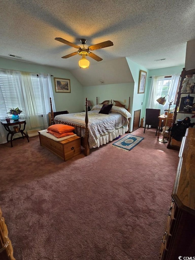 bedroom featuring ceiling fan, a textured ceiling, lofted ceiling, and dark carpet