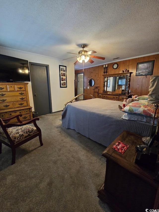 carpeted bedroom featuring ceiling fan, a textured ceiling, and wooden walls