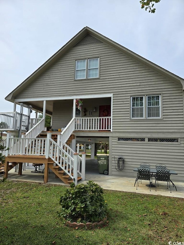 back of property featuring a patio area and a yard