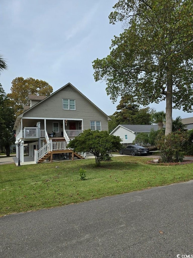 view of front of house with a porch and a front lawn