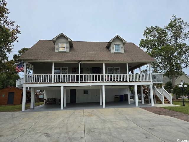 beach home featuring a carport and covered porch