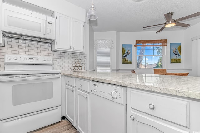 kitchen with white cabinetry, white appliances, tasteful backsplash, and a textured ceiling