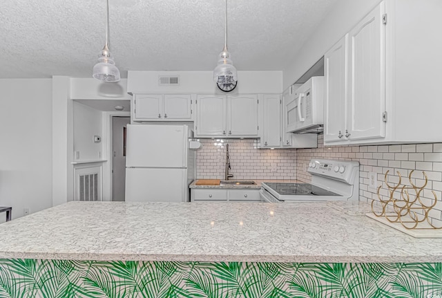 kitchen featuring pendant lighting, sink, white appliances, and white cabinets