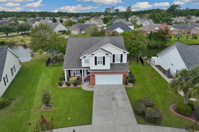 birds eye view of property with a water view