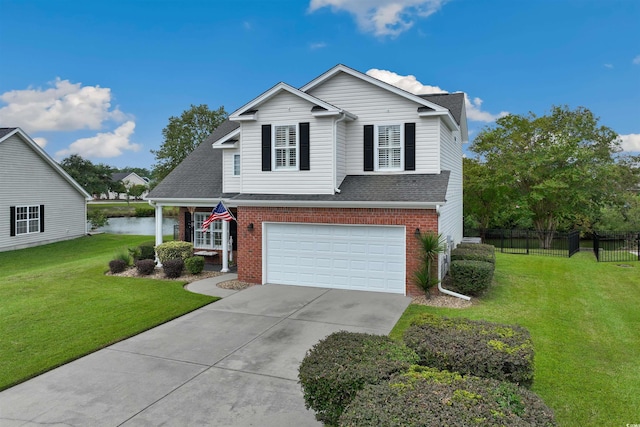 view of front of house with a water view, a garage, and a front yard