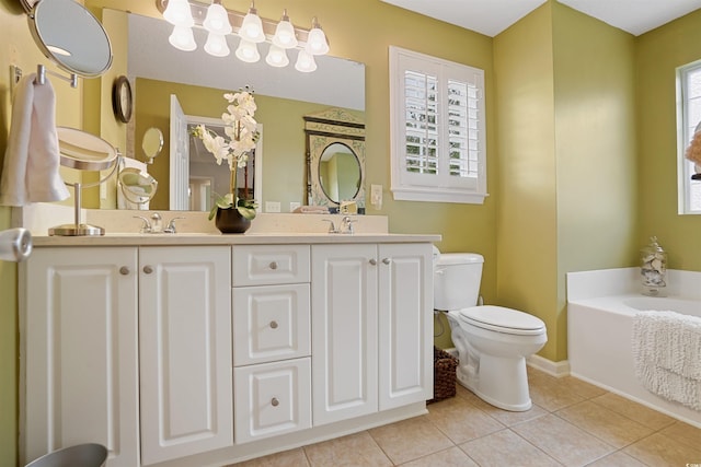 bathroom with vanity, tile patterned floors, toilet, and a bathing tub