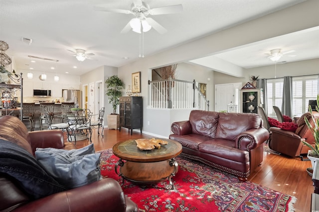 living room featuring hardwood / wood-style flooring and ceiling fan