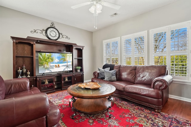 living room featuring wood-type flooring and ceiling fan