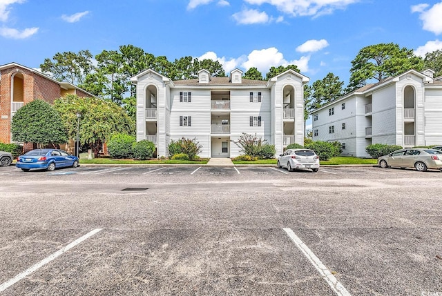 view of property featuring uncovered parking