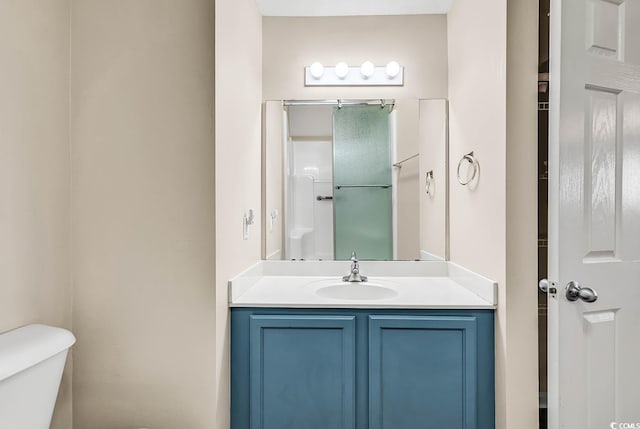 bathroom featuring vanity, toilet, and a shower