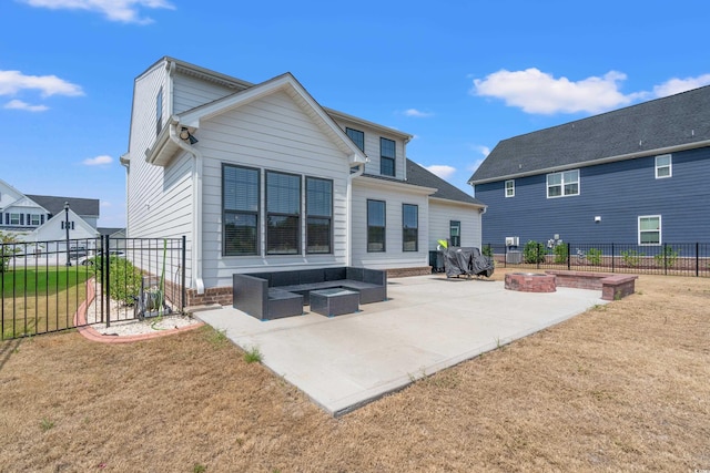 rear view of property with a lawn, an outdoor living space with a fire pit, and a patio