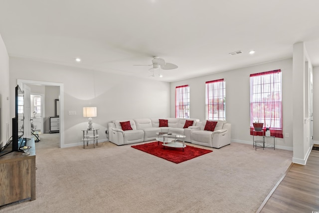 living room featuring light wood-type flooring and ceiling fan