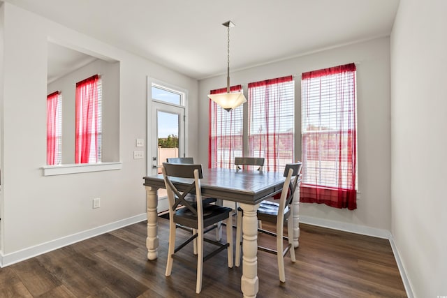 dining area with dark wood-type flooring and plenty of natural light